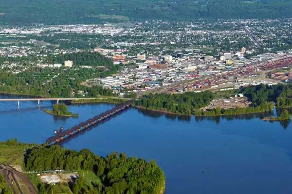 River flowing through a town surrounded by trees